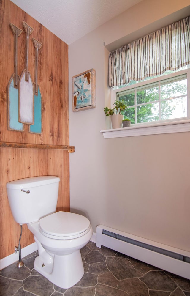 9 St James Pl, Lewiston, ME 04240 - half bathroom with a baseboard radiator and tile patterned flooring