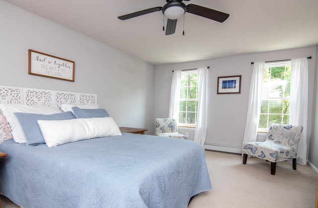 9 St James Pl, Lewiston, ME 04240 - carpeted bedroom with a baseboard heating unit and a ceiling fan