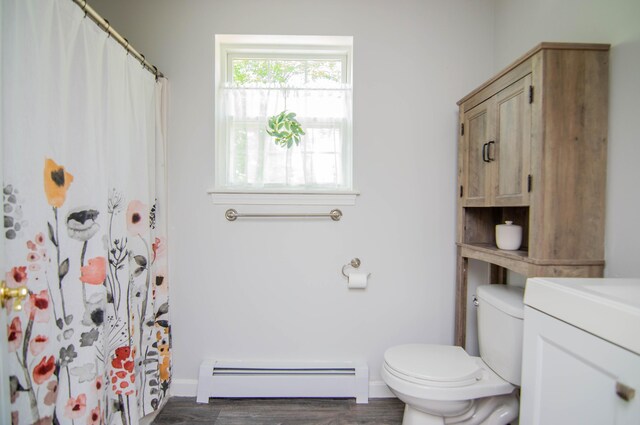 9 St James Pl, Lewiston, ME 04240 - bathroom featuring a baseboard heating unit, vanity, wood finished floors, and a shower with curtain