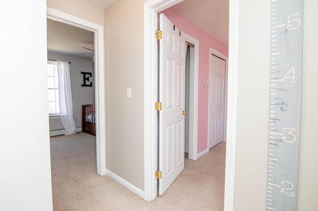 9 St James Pl, Lewiston, ME 04240 - corridor featuring light carpet, baseboard heating, and a baseboard heating unit