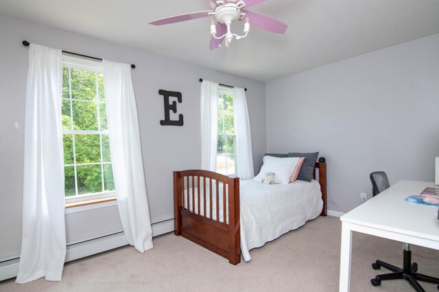 9 St James Pl, Lewiston, ME 04240 - carpeted bedroom with a desk, a baseboard radiator, and a ceiling fan