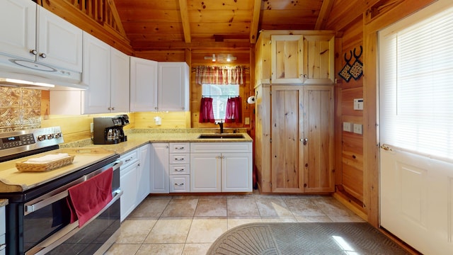 25 Loop Rd, Chester, ME 04457 - kitchen featuring stainless steel electric range, healthy amount of natural light, wood ceiling, white cabinetry, and wood walls