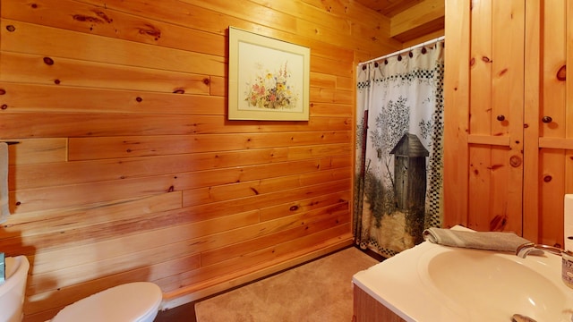 25 Loop Rd, Chester, ME 04457 - bathroom with wooden walls, vanity, and a shower with shower curtain
