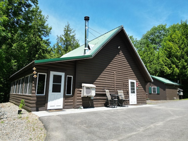 25 Loop Rd, Chester, ME 04457 - view of side of property featuring log veneer siding and a metal roof