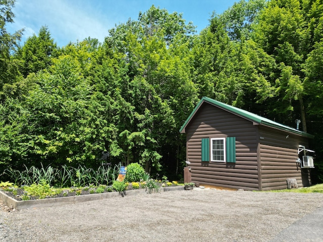 25 Loop Rd, Chester, ME 04457 - view of side of home featuring log veneer siding and an outbuilding