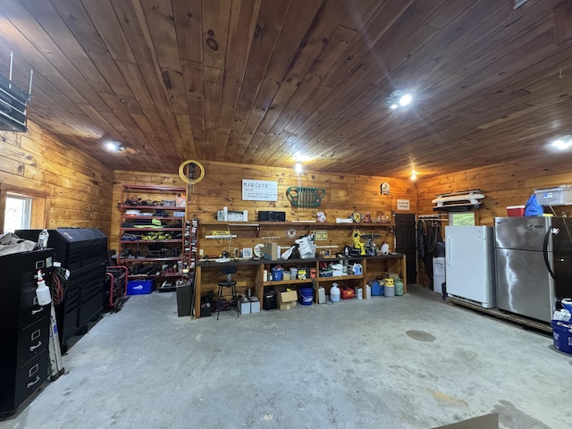 25 Loop Rd, Chester, ME 04457 - garage with freestanding refrigerator, a workshop area, and wooden walls
