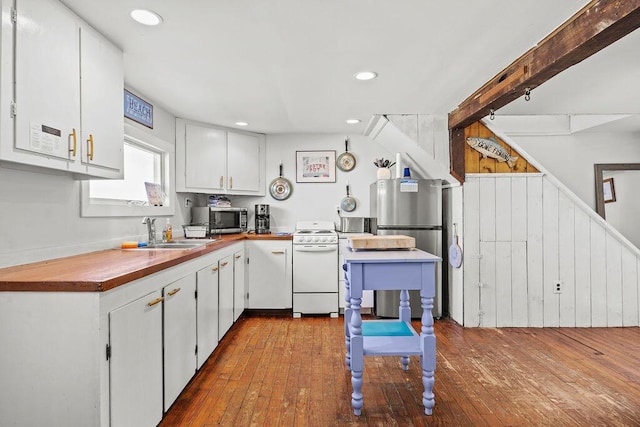 3 Surf Ave, Biddeford, ME 04005 - kitchen with stainless steel appliances, dark wood-type flooring, butcher block countertops, white cabinetry, and recessed lighting