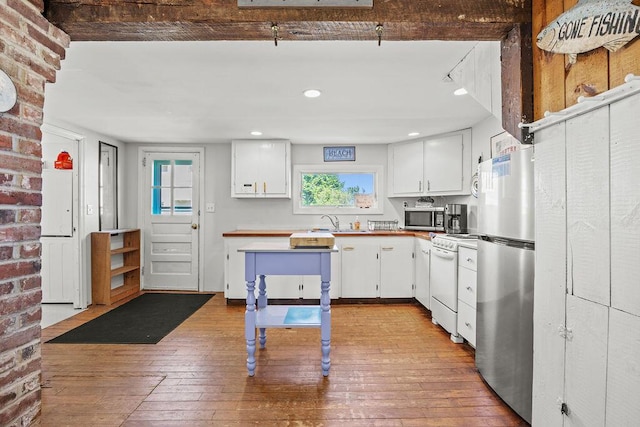 3 Surf Ave, Biddeford, ME 04005 - kitchen with stainless steel appliances, wood-type flooring, white cabinetry, and recessed lighting