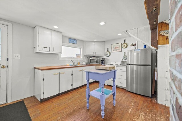 3 Surf Ave, Biddeford, ME 04005 - kitchen with stainless steel appliances, white cabinets, light wood-type flooring, and recessed lighting