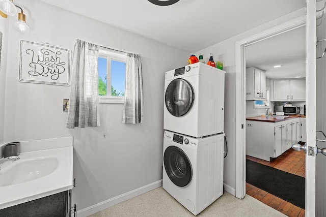 3 Surf Ave, Biddeford, ME 04005 - laundry room with stacked washer and clothes dryer, light wood-type flooring, and recessed lighting