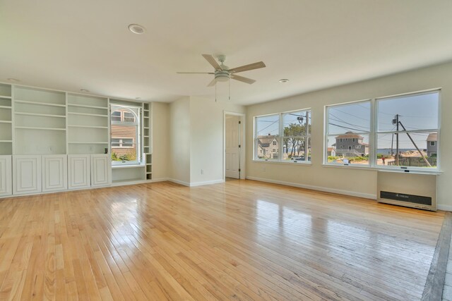 9 Riverside Ave, Saco, ME 04072 - empty room with plenty of natural light, a ceiling fan, light wood-style floors, and heating unit