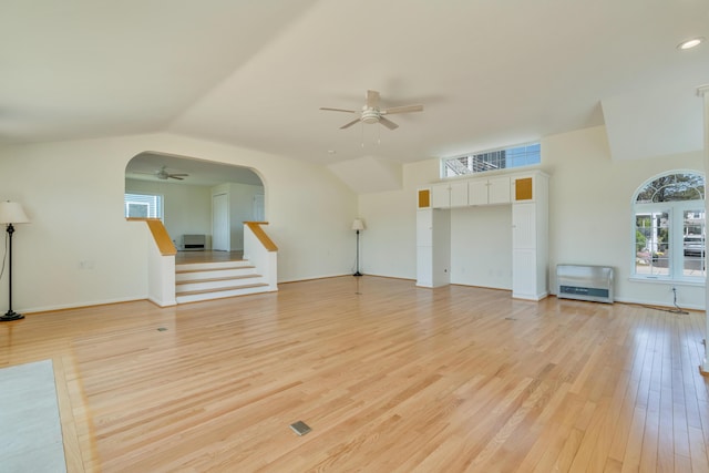 9 Riverside Ave, Saco, ME 04072 - unfurnished living room with ceiling fan, heating unit, light wood-style floors, arched walkways, and stairs