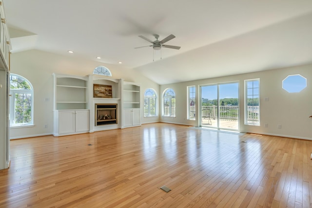 9 Riverside Ave, Saco, ME 04072 - unfurnished living room featuring lofted ceiling, plenty of natural light, ceiling fan, light wood-style floors, and a fireplace