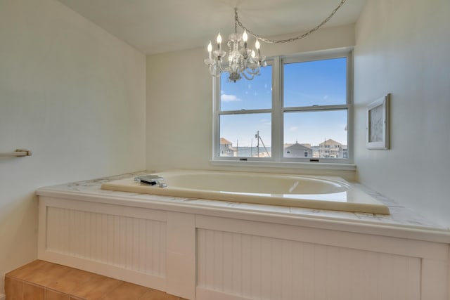9 Riverside Ave, Saco, ME 04072 - bathroom featuring a bath and a chandelier