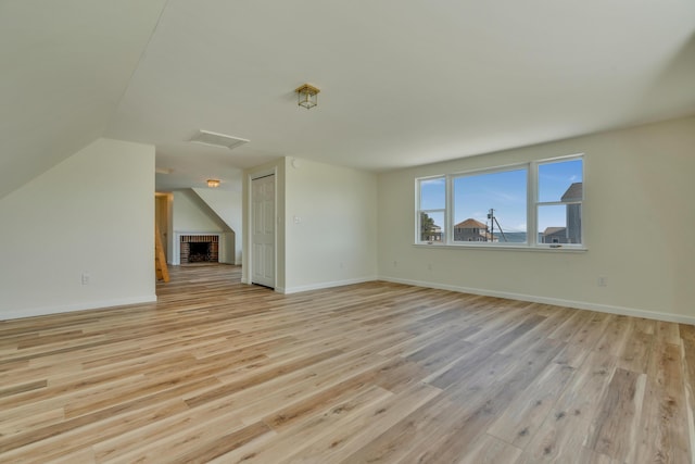 9 Riverside Ave, Saco, ME 04072 - unfurnished living room with light wood finished floors, attic access, and vaulted ceiling