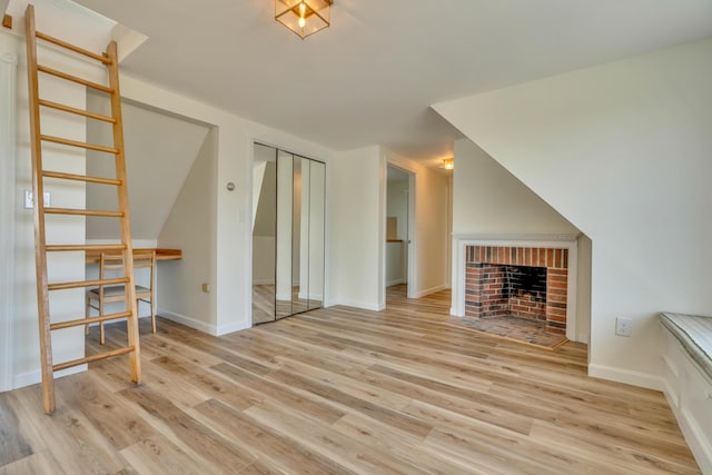 9 Riverside Ave, Saco, ME 04072 - unfurnished living room with wood finished floors and a brick fireplace