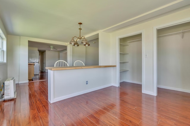 9 Riverside Ave, Saco, ME 04072 - kitchen featuring a chandelier, dark wood-type flooring, hanging light fixtures, and built in shelves