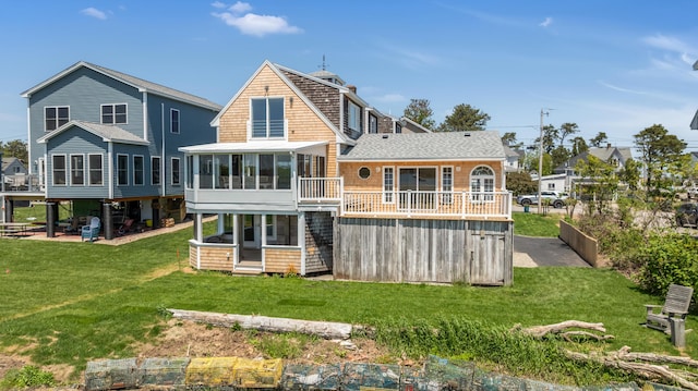 9 Riverside Ave, Saco, ME 04072 - back of house featuring a sunroom, a shingled roof, and a lawn