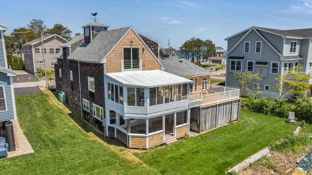 9 Riverside Ave, Saco, ME 04072 - rear view of house with a standing seam roof, a sunroom, a yard, and roof with shingles