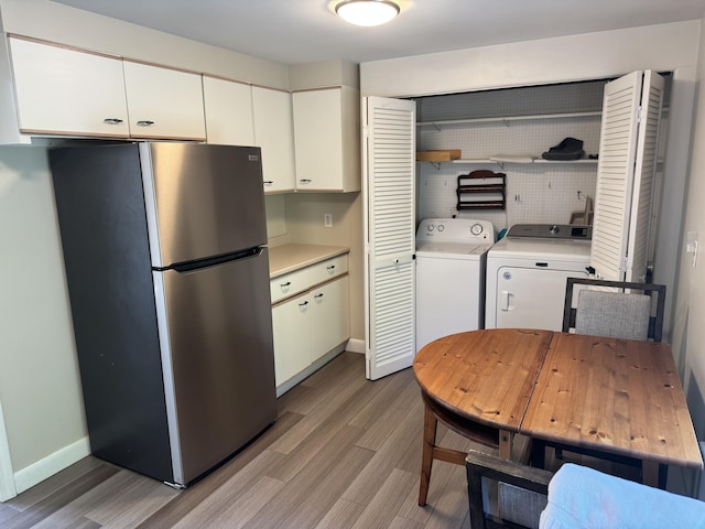 25 Minott St Unit 9, South Portland, ME 04106 - kitchen featuring freestanding refrigerator, washer and dryer, open shelves, and light wood-type flooring