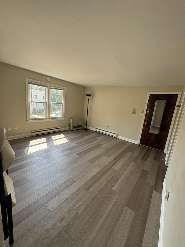 25 Minott St Unit 9, South Portland, ME 04106 - empty room with a baseboard radiator and dark wood finished floors