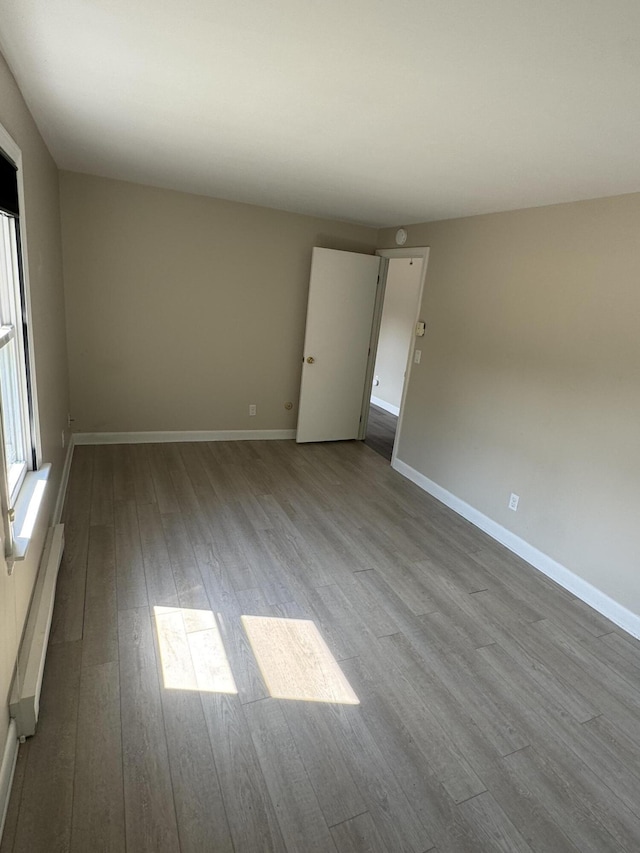 25 Minott St Unit 9, South Portland, ME 04106 - spare room featuring wood finished floors and a baseboard radiator