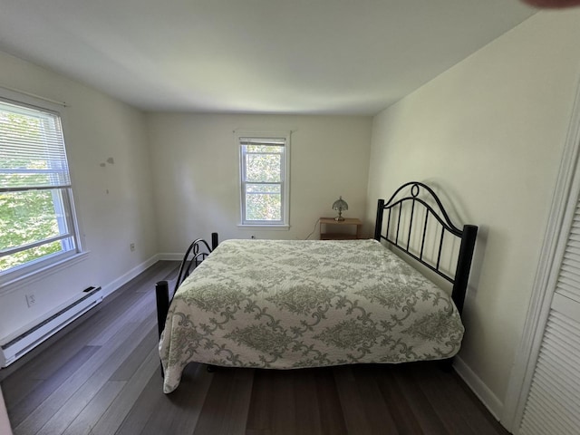 25 Minott St Unit 9, South Portland, ME 04106 - bedroom featuring a baseboard radiator, multiple windows, and dark wood-style floors