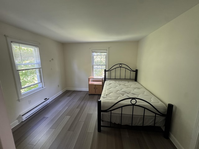 25 Minott St Unit 9, South Portland, ME 04106 - unfurnished bedroom featuring baseboard heating and wood finished floors