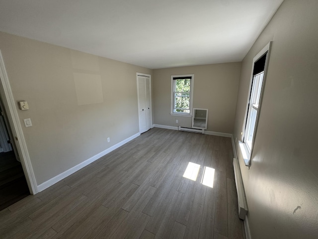 25 Minott St Unit 9, South Portland, ME 04106 - empty room with baseboard heating and dark wood-style flooring