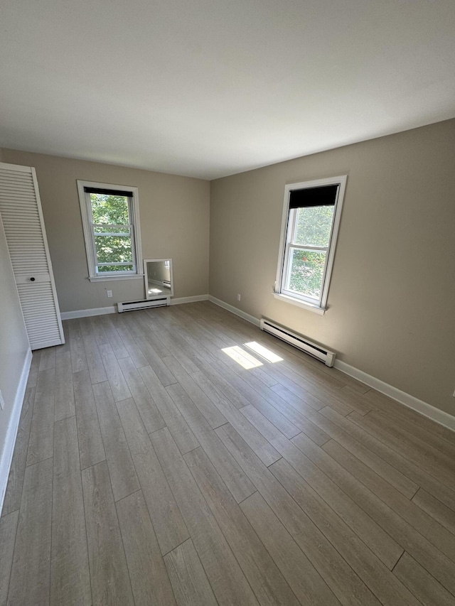 25 Minott St Unit 9, South Portland, ME 04106 - spare room featuring a baseboard radiator, plenty of natural light, and wood finished floors