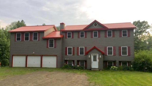 142 Abbott Rd, Albion, ME 04910 - split foyer home featuring a chimney, a front lawn, an attached garage, and driveway