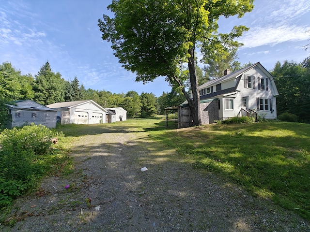 1052 Douty Hill Rd, Sangerville, ME 04479 - view of green lawn featuring driveway and an outdoor structure