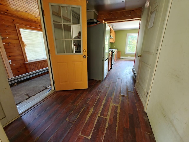 1052 Douty Hill Rd, Sangerville, ME 04479 - hallway with dark wood-style flooring, a baseboard radiator, and wooden walls