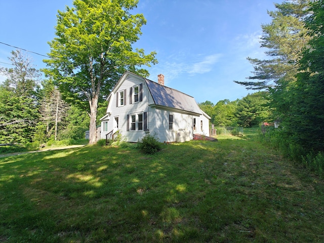 1052 Douty Hill Rd, Sangerville, ME 04479 - view of side of home with a chimney, a yard, a gambrel roof, and a metal roof