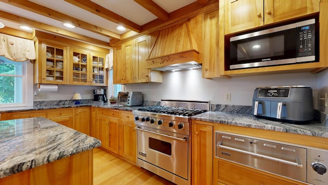 486 Webbs Mills Rd, Raymond, ME 04071 - kitchen with appliances with stainless steel finishes, a warming drawer, premium range hood, light wood-type flooring, and glass insert cabinets