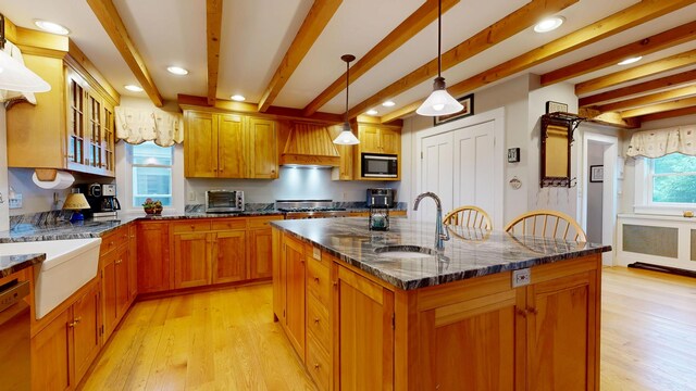 486 Webbs Mills Rd, Raymond, ME 04071 - kitchen featuring beam ceiling, built in microwave, light wood-type flooring, a center island with sink, and premium range hood