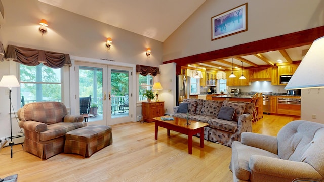 486 Webbs Mills Rd, Raymond, ME 04071 - living area featuring light wood finished floors, french doors, healthy amount of natural light, high vaulted ceiling, and a baseboard radiator
