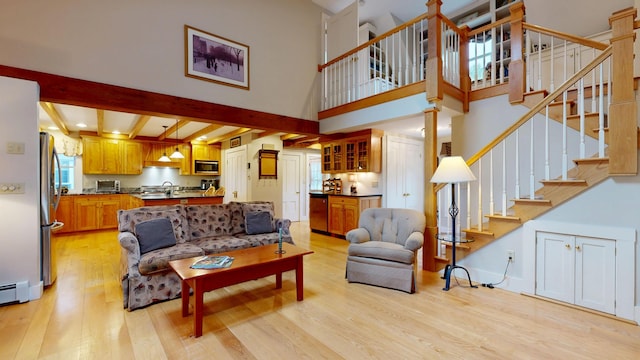 486 Webbs Mills Rd, Raymond, ME 04071 - living area with light wood-style floors, stairs, healthy amount of natural light, beam ceiling, and a high ceiling
