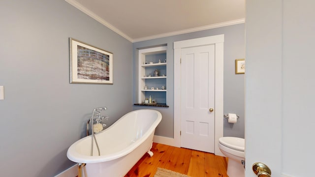 486 Webbs Mills Rd, Raymond, ME 04071 - bathroom featuring a soaking tub, wood finished floors, crown molding, and built in shelves