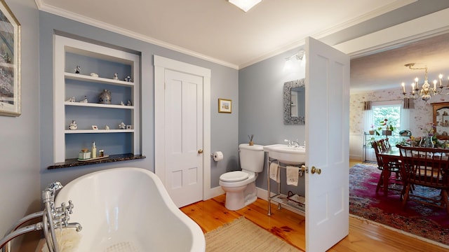 486 Webbs Mills Rd, Raymond, ME 04071 - full bathroom with wood finished floors, a freestanding tub, a chandelier, built in shelves, and ornamental molding