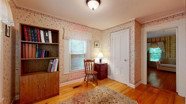 486 Webbs Mills Rd, Raymond, ME 04071 - sitting room with wood-type flooring, wallpapered walls, healthy amount of natural light, and ornamental molding