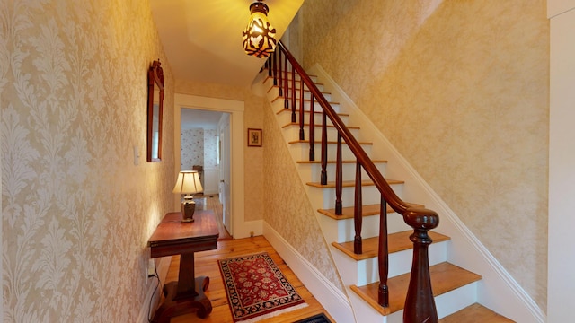 486 Webbs Mills Rd, Raymond, ME 04071 - stairway with wallpapered walls and wood finished floors