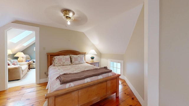 486 Webbs Mills Rd, Raymond, ME 04071 - bedroom with a skylight, lofted ceiling, light wood-type flooring, and a ceiling fan