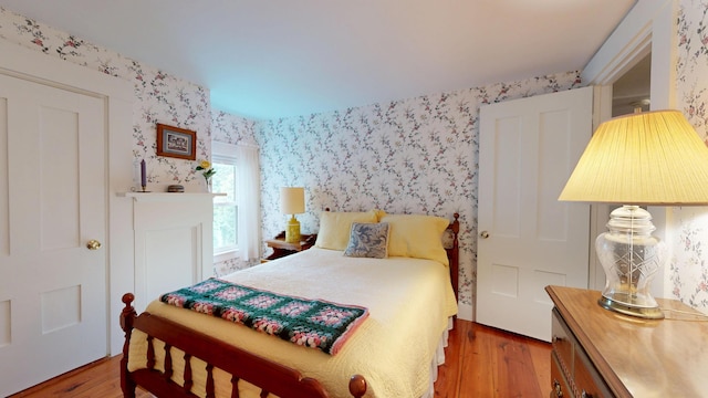 486 Webbs Mills Rd, Raymond, ME 04071 - bedroom featuring wallpapered walls and wood finished floors