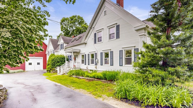 486 Webbs Mills Rd, Raymond, ME 04071 - view of front of house with a chimney, an outbuilding, and driveway