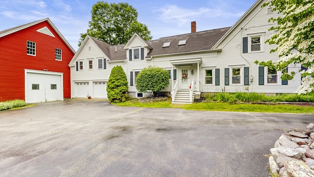 486 Webbs Mills Rd, Raymond, ME 04071 - view of front of house featuring a chimney, driveway, a shingled roof, and an attached garage