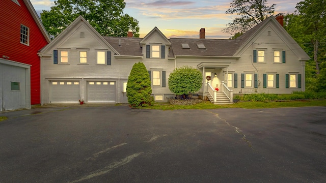 486 Webbs Mills Rd, Raymond, ME 04071 - view of front of home with driveway, a chimney, and an attached garage