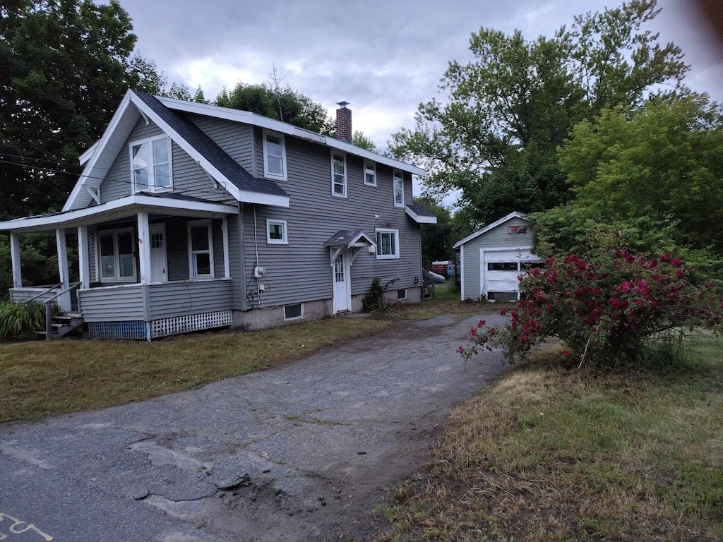 6 Fowler St, Augusta, ME 04330 - view of front of property featuring a chimney, driveway, a porch, an outbuilding, and a detached garage