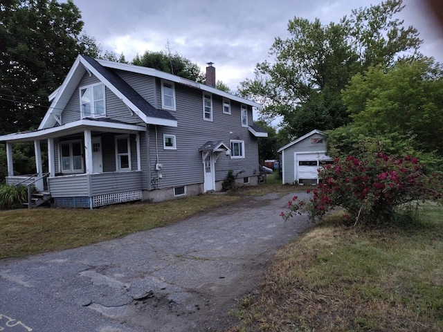 6 Fowler St, Augusta, ME 04330 - view of front of property featuring a chimney, driveway, a porch, an outbuilding, and a detached garage