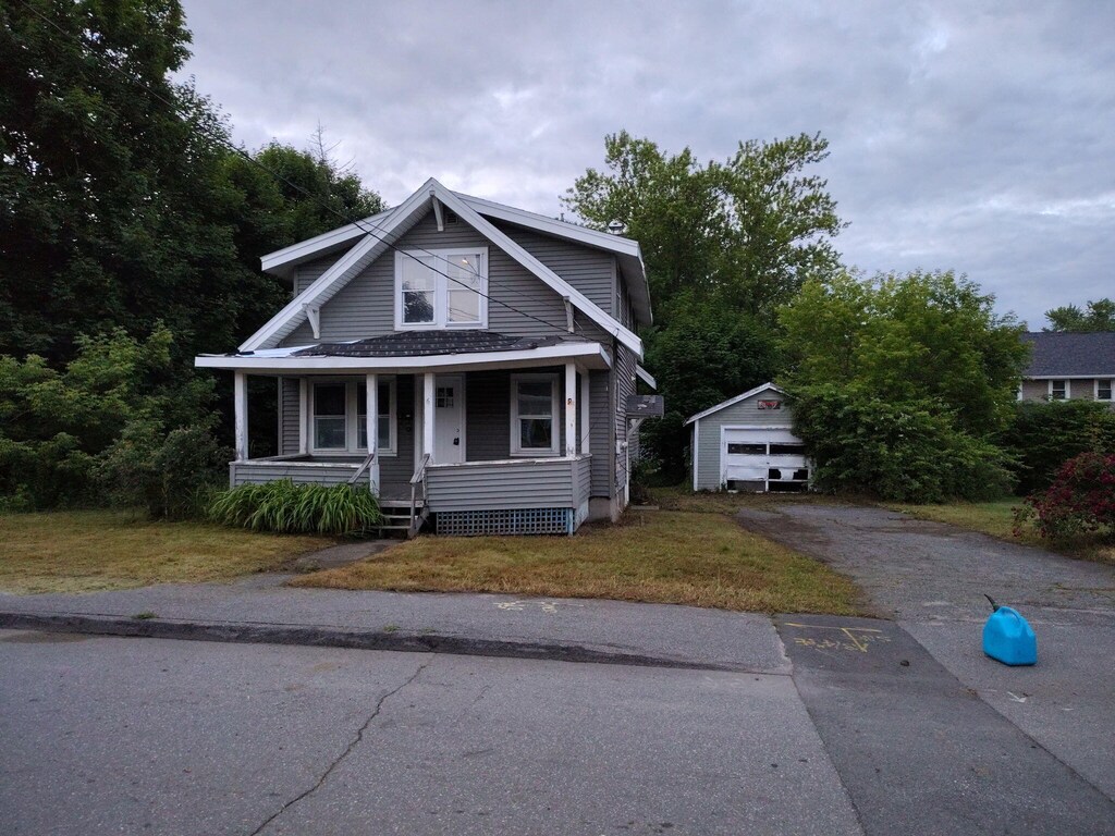 6 Fowler St, Augusta, ME 04330 - bungalow with an outdoor structure, a porch, a garage, driveway, and a front yard